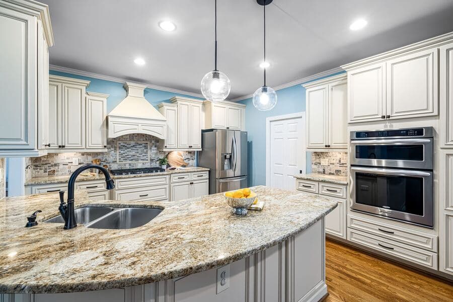 A bright, spacious kitchen with wood cabinets, a kitchen island, and modern appliances